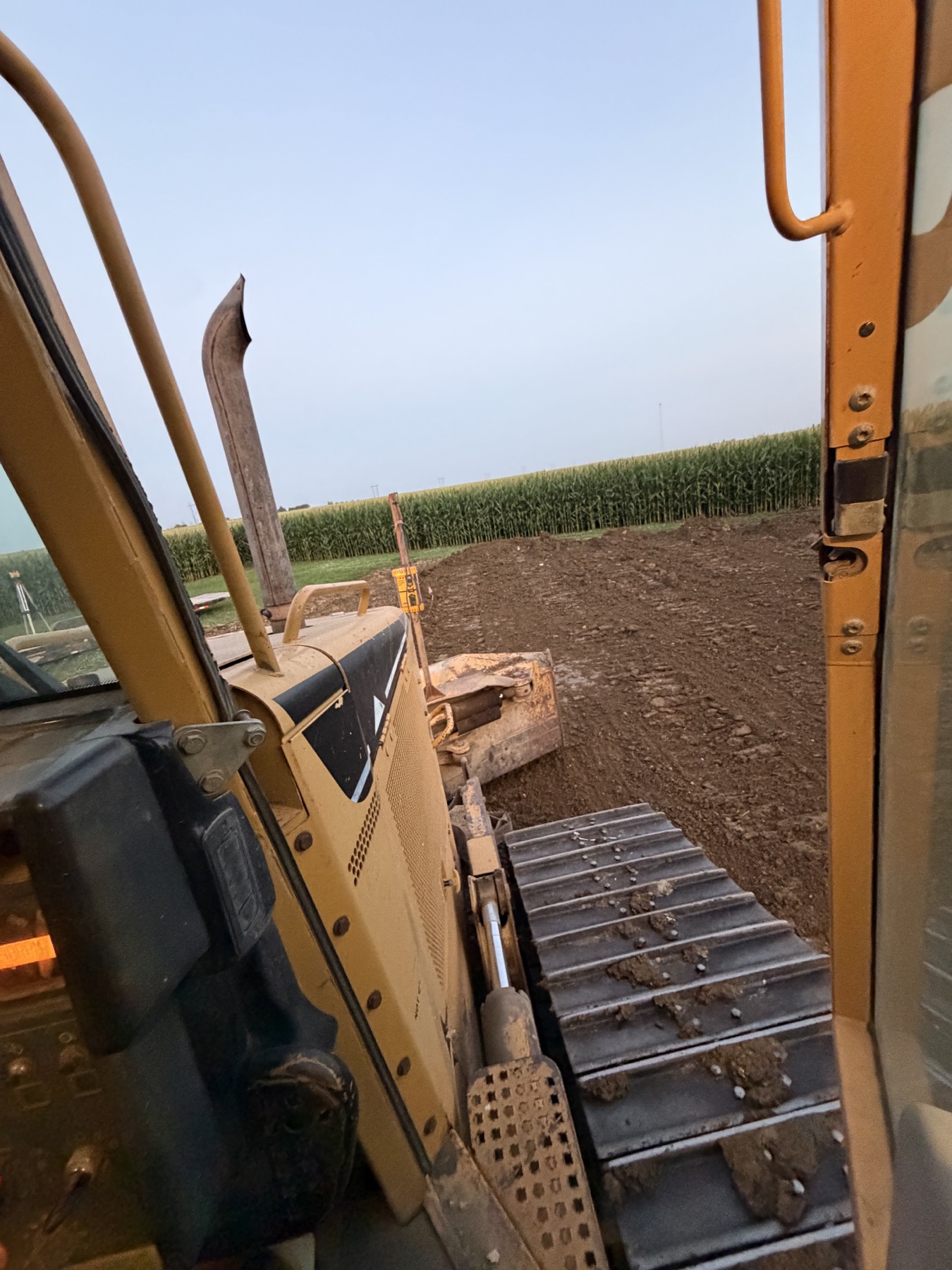 Dozer using laser grade control on a clay building pad in Harcourt Iowa