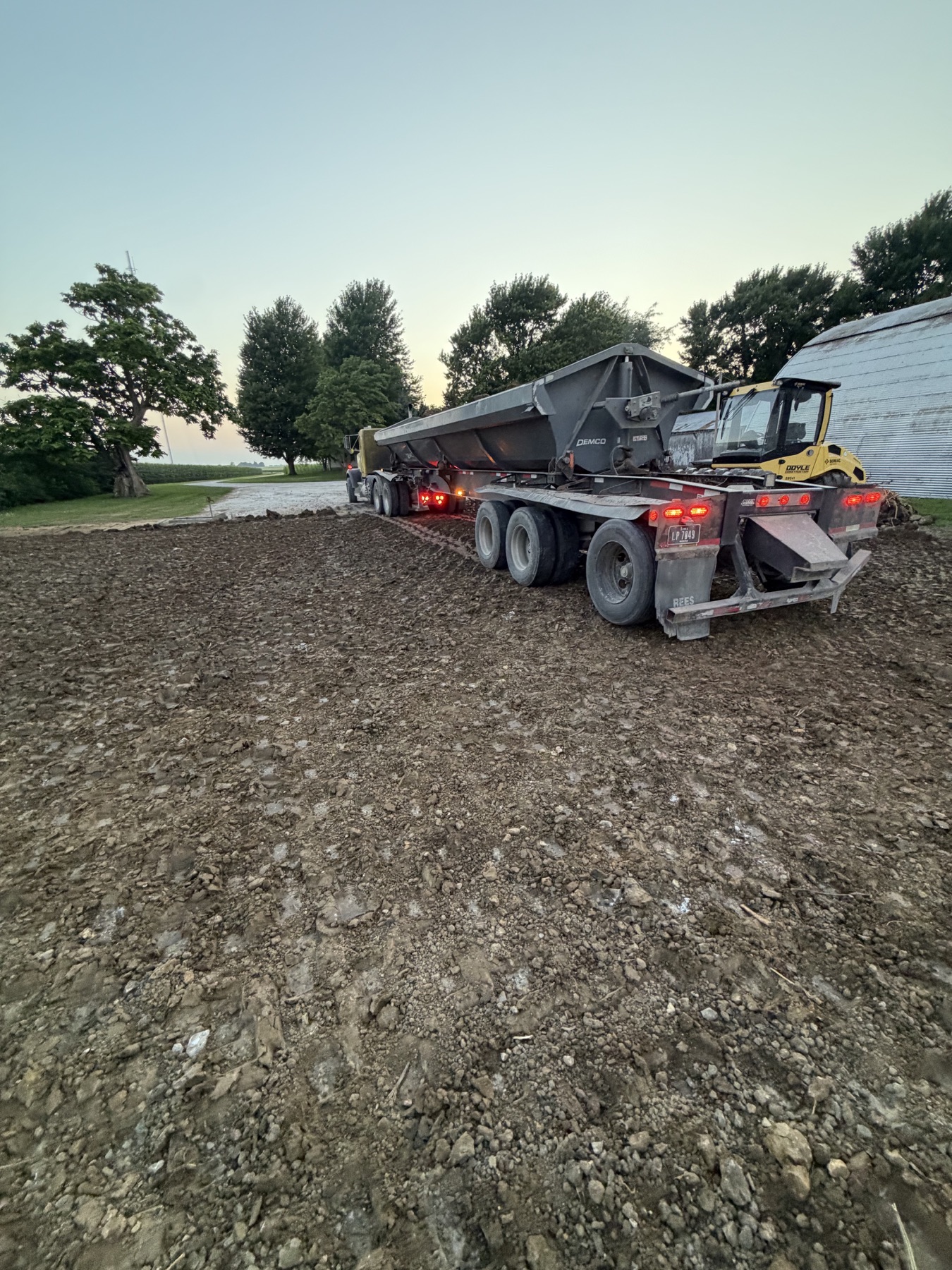 Doyle Transit side dump delivering clay onto a Harcourt Iowa building pad